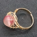 Handmade gold wire-wrapped ring featuring a 10mm pink and white marble natural stone bead - Watermelon Quartz
