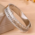 Macro shot of silver Greek key pattern bangle with sparkling cubic zirconia inlays - Steel Double Row Diamond Meander Pattern Bangle / Steel