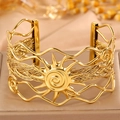 Ethnic bohemian open cuff bracelet in golden finish with sun motif and woven steel details - Open Rune Style / Gold Woven Sun