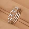 Macro view of polished silver stainless steel bracelet with cutout teardrop patterns - Steel