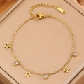 Elegante bracciale in acciaio al titanio dorato con ciondoli a stella e cristalli su scatola - Oro Stella A Cinque Punte