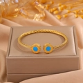 Bracelet jonc torsadé doré avec incrustation d'œil bleu et motifs grecs - Motif Cercle Bleu