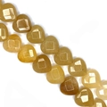 Macro detail of heart-shaped yellow translucent stone beads with white etched symbols - 15x15x8mm (Approx. 14 Beads) / Topaz