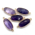 Macro detail of faceted purple amethyst connectors with gold plated edges for jewelry - Amethyst