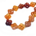 Close-up of 14mm double-sided flower-shaped beads in natural semi-precious stone - 14mm / Red Agate