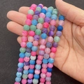 Handheld view of colorful weathered agate round beads with unique dragon vein patterns - 6mm / Rainbow No.1