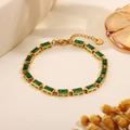 Gold tone chain bracelet featuring emerald cut green stones and adjustable lobster clasp - Emerald Green Rectangular Bracelet