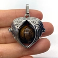 Silver heart-shaped wing pendant locket with a tiger eye stone bead inside - Tiger's Eye