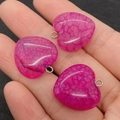 Three rose red dragon vein agate heart pendants in hand showing size and stone texture - Rose Red Style (1)