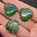 Macro shot of three heart-shaped green dragon vein agate pendants held in palm - Green Style (3)