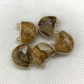 Macro detail of semi-circle natural stone connectors with gold plated dual loops - 17x18mm / Picture Jasper