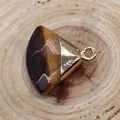 Polished tiger eye stone fan-shaped pendant with golden metal cap on wood background - Tiger's Eye