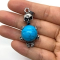 Punk style silver skull pendant holding a blue turquoise bead on a palm background - 20x42mm / Dark Blue Turquoise