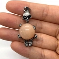 Gothic silver skull pendant holding a large spherical pink quartz stone on hand - 20x42mm / US 10