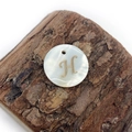 Macro view of natural freshwater shell pendant with golden letter H for DIY jewelry making - Letter H