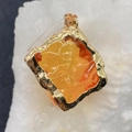 Irregular square orange natural stone pendant with gold textured metal edge and top bail - 18mm