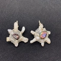Detailed view of handmade silver wire wrapped star pendants with baroque pearls - US 2