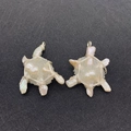 Detail of handmade baroque pearl turtle and star pendants with crystal wire wrapping - US 3