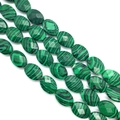 Macro shot of malachite faceted oval beads showing green wavy patterns for DIY jewelry - 10x14x6mm/15Pcs / Malachite
