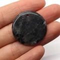 Handheld view of a 30mm natural speckled stone circular pendant for DIY necklaces - 30MM / Dark Grey Ore (No. 6)