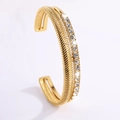 Double-layered gold titanium steel open bangle with herringbone texture and pave crystals - Cast Open Side Rhinestone Arrow