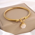 Golden twisted cable bracelet with a round white faux pearl pavé charm on jewelry box - Pearl Pendant Horseshoe