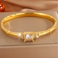 Detailed close-up of a luxury gold titanium steel bangle with a large square zircon and side diamonds - Gold Large Square Diamond Bracelet