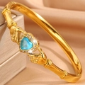 Golden heart-shaped Claddagh bracelet with light blue gemstone and shimmering diamonds - Gold Blue Gemstone Bangle