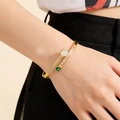 Gros plan d'un bracelet doré à deux rangs avec des cœurs d'émeraude et de la zircone - Couleur Or (Cœurs Émeraude et Nacre)