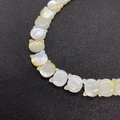 Macro shot of cat-shaped natural shell beads with iridescent pearly luster for jewelry DIY - Cat Head Shape Style / Pearl Iridescent White