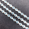 Macro view of white mother of pearl Hamsa Hand beads with blue evil eye for DIY jewelry - Vertical Hole Hamsa Style / Large