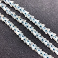 Macro detail of butterfly shaped shell beads with blue evil eye inlay for DIY jewelry - Butterfly Design / Medium