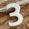 Macro view of natural white shell bead shaped like number 3 for DIY necklace jewelry making - Number 3 / 6x10mm, 1g