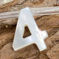 Macro shot of letter A natural seashell bead with iridescent luster for DIY necklace - Number 4 / 6x10mm, 1g
