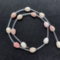 Détail macro de perles en nacre en forme de tulipe rose et blanc pour bijoux DIY - Magnolia