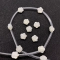 Macro shot of white carved shell rose beads with iridescent luster for DIY jewelry making - 8mm / Rose