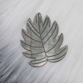 Leaf-shaped black shell pendant with natural iridescent luster and intricate engravings - Black Shell Leaf