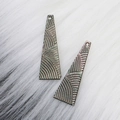 Deep-toned black shell teardrop charms with iridescent luster and fine radial textures - Trapezoid/Long Triangle