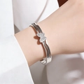 Close-up of titanium steel hollow butterfly bangle with diamond-set accents and geometric pattern - Silver Butterfly Zircon Bangle
