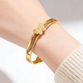Detail of a gold butterfly bangle with rhinestones and hollow patterns on a wrist - Gold Butterfly Rhinestone Bangle