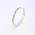 Close-up of silver steel cuff with Greek key pattern and sparkling crystal border - Meander Rhinestone Style / Silver