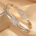 Detail of silver butterfly bangle with diamond accents and Greek meander pattern - Silver