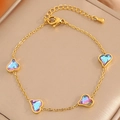 Détail du bracelet en acier doré avec breloques cœurs et cristaux bleu et violet - Style Cœur Coloré