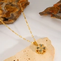 Detail of clover pendant necklace with green stones and zircons on natural stones - Rotating Blue Zirconia Clover Necklace