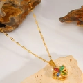 Detailed close-up of a golden spinning flower necklace with colorful crystals on a natural rock - Colorful
