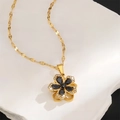 Close-up of golden titanium necklace with black zircon five-petal flower pendant - Black Zirconia Flower Pendant Necklace