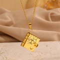 Golden book locket necklace with heart detail and fine chain on stone pedestal - Hand in Hand Daughter All Gold