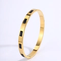 Gold plated stainless steel bangle featuring embedded rectangular black gemstones - Gold - Black Zirconia
