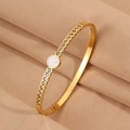 Golden titanium steel bangle with inlaid crystals and a polished white shell disk - White Round Rhinestone Bangle