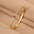 Polished gold titanium steel bangle with central red gemstone and crystal pavé details - Red Round Rhinestone Bangle